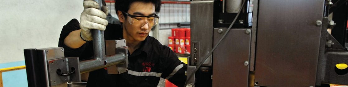 Man filling oil in drum