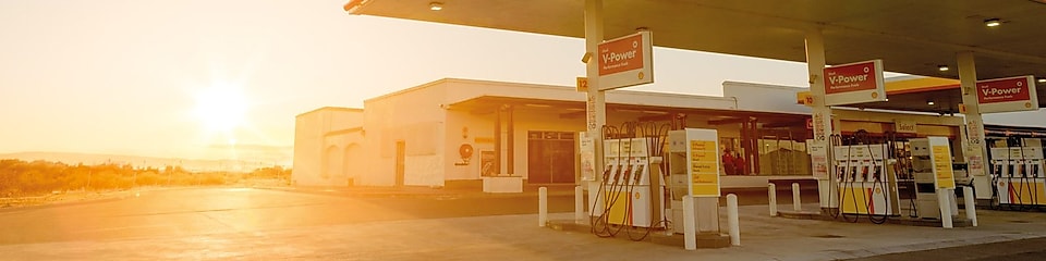 The forecourt of a shell service station at dusk