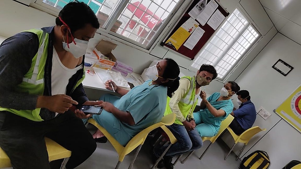 Healthcare workers administer the first dose of COVID-19 vaccine to Shell staff in Pune