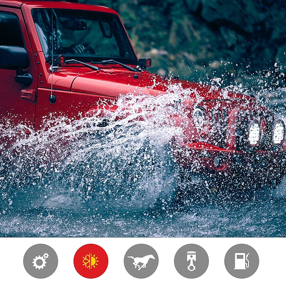 A red jeep splashes through a riverbed, indicating the extreme temperature performance product benefit