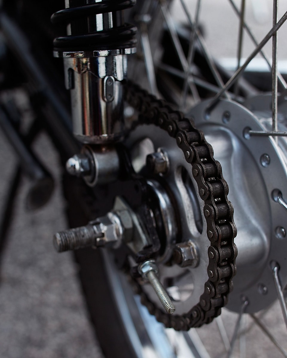 a motorcycle chain attached to the back wheel