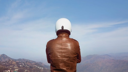 person in brown jacket and white helmet