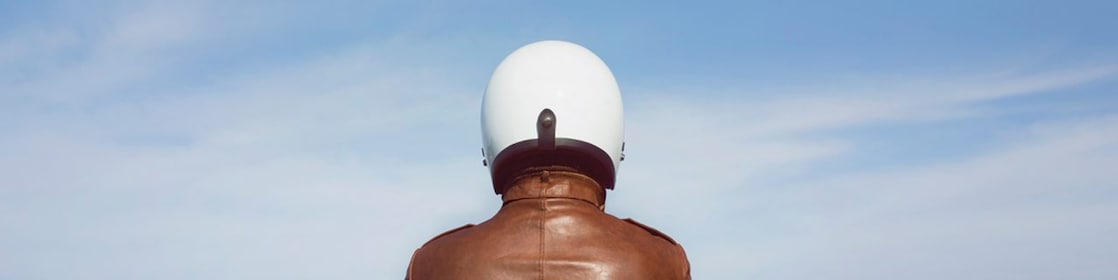 person in brown jacket and white helmet