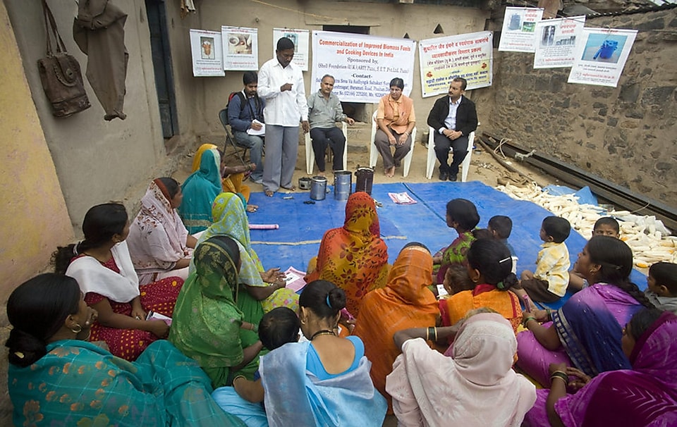 Volunteers speaking to villagers